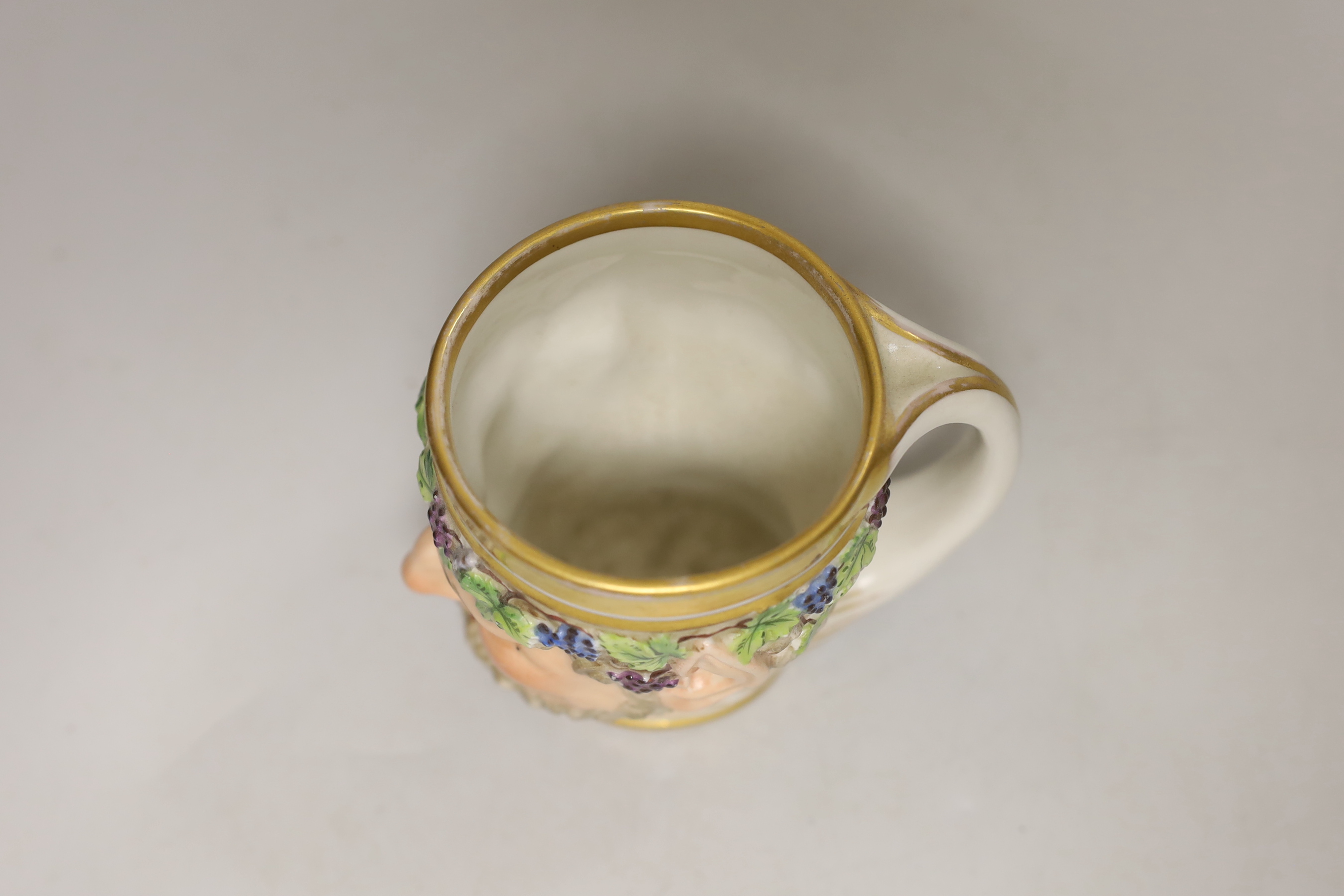 A Vienna porcelain satyr cup, impressed number 827, possibly for the date 1827, 10cm high